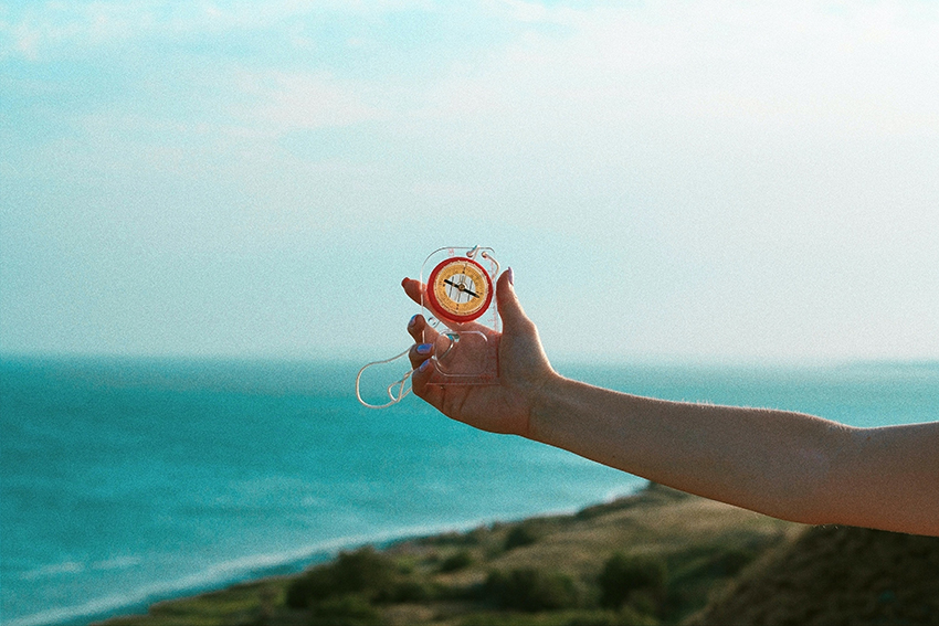 Image of hand holding a compass, representing brand purpose and moral compass