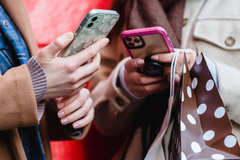 Close-up of university students texting on their mobile phones